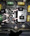 I tested each of the relay connections - the results are as follows: 
30 = ground measured 12.69v
87 = Hot 12.69v
85 = Hot 12.69v
86 = Ground 8.18v